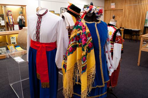 These costumes are from the Barvinok Ukrainian Dancers of the Holy Ghost Ukrainian Catholic Church in Sydney, Nova Scotia. The pair of costumes with blue pants and vest is representative of the central Poltava region. / Costumes: Kenny Horechuk and Woman’s Poltava Costume (blue vest): Darlene Baggio / CKP_4000