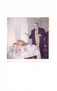 Father Zarsky blessing Easter food at Zwarun family house. 