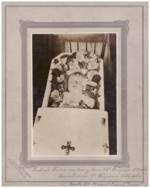 Photograph of child in coffin. Caption reads: 'Ludwik Kuna, born August 25, 1925, died September, 1926.' Signed: 'Wrote by Michael Trach "Tracz"'.