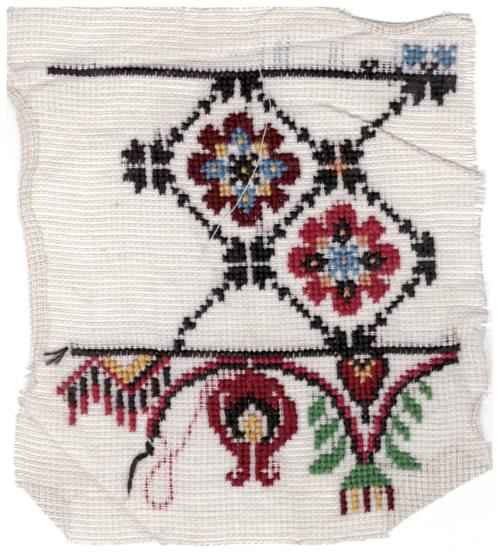 Sample of embroidery with flowers, of dark red, red blue and purple. 